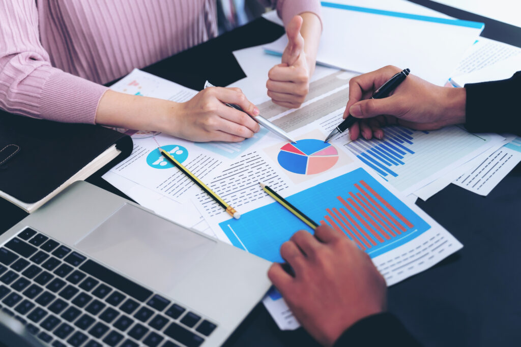 close-up-hand-business-man-busy-office-desk-notebook-documents-working